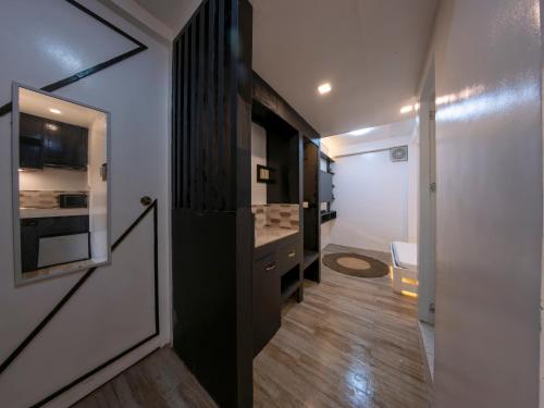 a small room with a hallway with a door and a room with at Sip Sunset Hostel and Lounge in El Nido