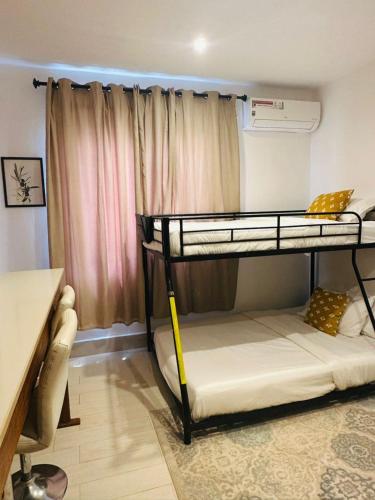 a dorm room with two bunk beds in it at Luxury & Comfort, with Pool and Ocean Views in Bijilo