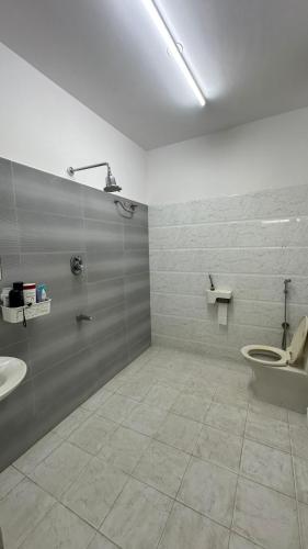 a bathroom with a toilet and a sink at Simba Stay's 2BHK 1 in Chikmagalūr