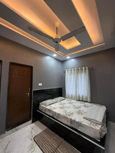 a bed in a room with a ceiling at Simba Stay's 2BHK 1 in Chikmagalūr