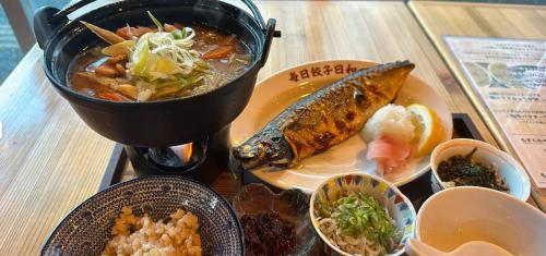 a table with a plate of food on a table at hotel gala city only 5 mins to Kokusai Street 24 square meters room in Naha