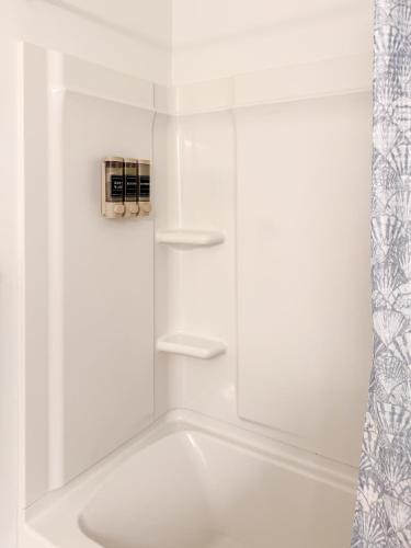 a white bath tub with shelves in a bathroom at Downtown Atlanta Home Away From Home in Atlanta