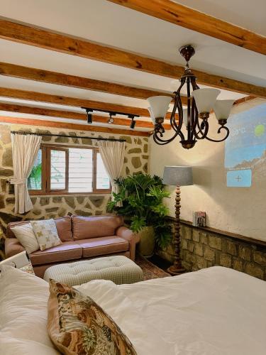 a bedroom with a bed and a living room at SIA Home in Da Lat