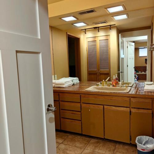 a bathroom with a sink and a large mirror at Star Lake Shores in Kent