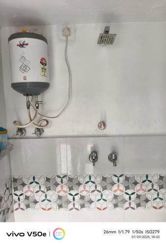 a bathroom with a toilet and a tiled floor at Little prince guest house & homestay in Bikaner