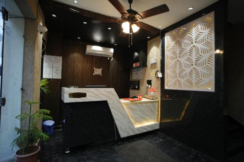 a restaurant with a counter in a room at Hotel Mantra Inn in Haridwār