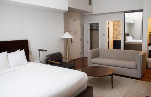 a hotel room with a bed and a couch at StayCozy at The Arco in Philadelphia