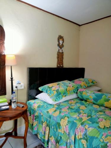 a bedroom with a bed with a teddy bear on the wall at pondok tegal jero in Jatiluwih