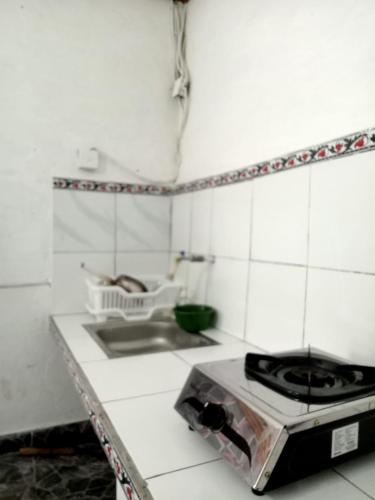 a kitchen with a stove and a counter top at pondok tegal jero in Jatiluwih