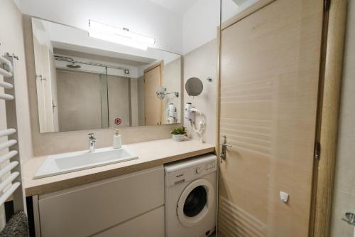 a bathroom with a sink and a washing machine at Bella Vista - Historic Centre -4th floor in Corfu