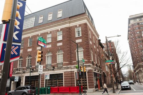 a building on the corner of a city street at StayCozy at The Arco in Philadelphia
