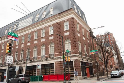 a large brick building on the corner of a street at StayCozy at The Arco in Philadelphia
