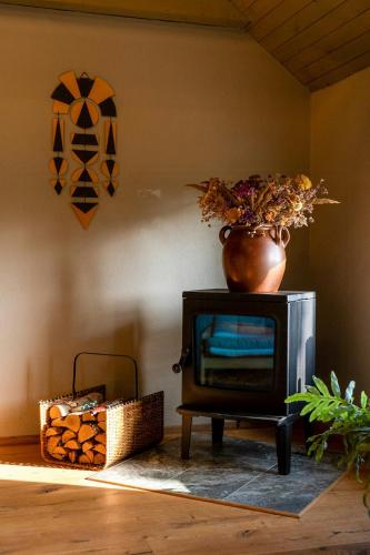 a television sitting on a table with a vase on top at Restored House With Art In Österlen in Borrby