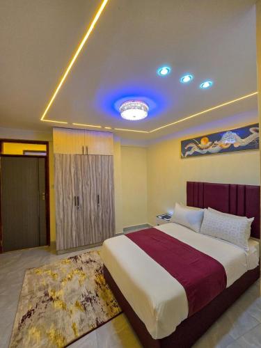 a bedroom with a large bed and a blue light at Monte Opulent Haven in Eldoret
