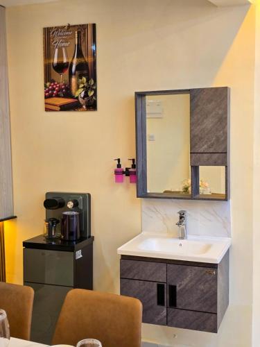 a bathroom with a sink and a mirror at Monte Opulent Haven in Eldoret