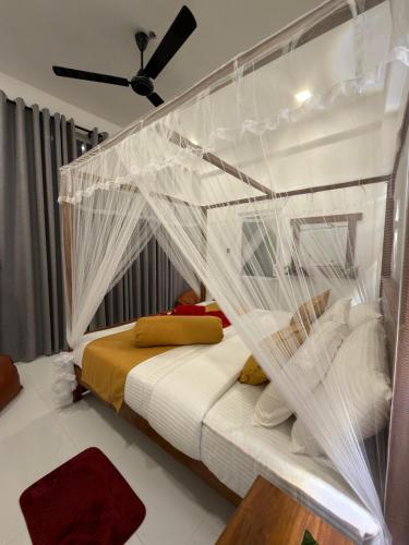 a bedroom with a bed covered in netting at Flower Resort Ella in Ella