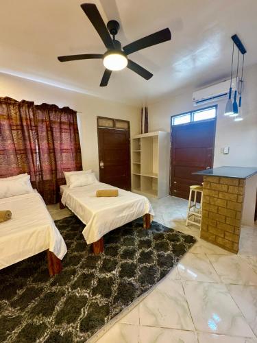 a bedroom with two beds and a ceiling fan at Ohana Trining in General Luna
