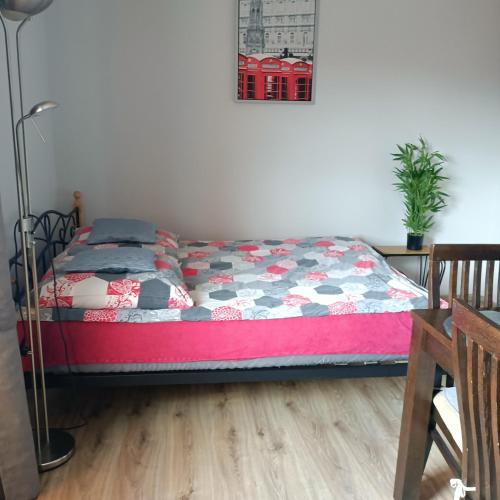 a bedroom with a bed with a quilt on it at Apart Bella in Uniejow