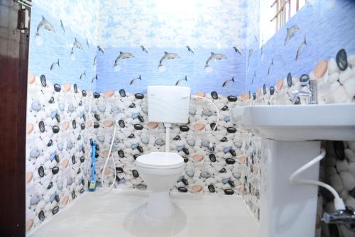 a bathroom with a toilet and a sink at BlueMoon Homestay - Near to Falls and View Points, Home Food & Estate in Sakleshpur
