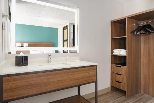 a bathroom with a sink and a mirror at Hyatt Place Scottsdale/Old Town in Scottsdale
