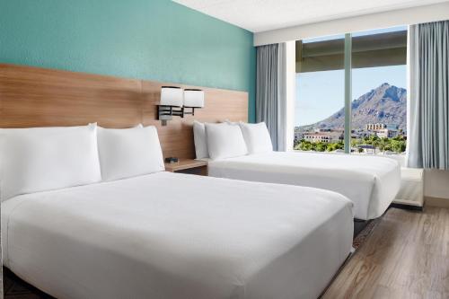 a hotel room with two beds and a window at Hyatt Place Scottsdale/Old Town in Scottsdale