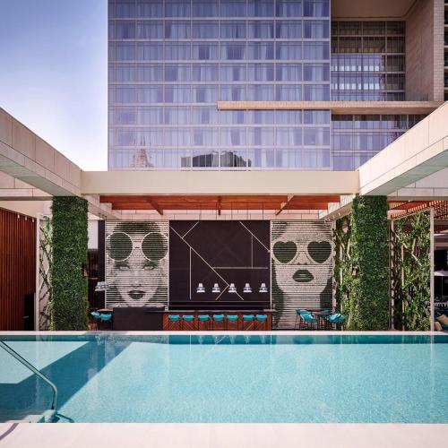 a pool in front of a tall building at Waldorf Astoria Dubai International Financial Centre in Dubai