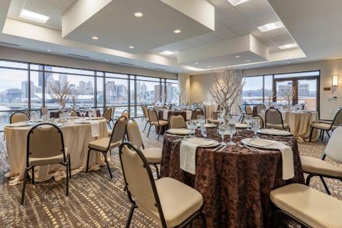 a banquet room with tables and chairs and windows at Comfort Inn & Suites Pittsburgh-Northshore in Pittsburgh