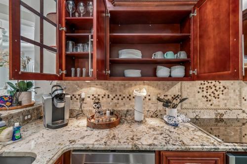 a kitchen with wooden cabinets and a counter top at 3br,3ba home near Downtown and Airport, Walk to the Stadium in Tampa