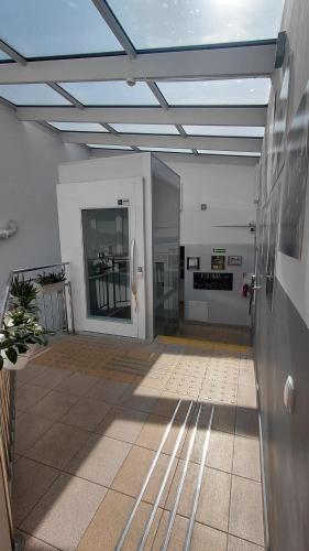 a large room with a hallway with a building at Blues Hostel in Konin