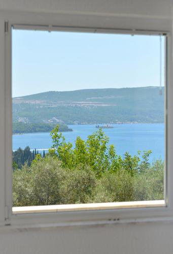 a window with a view of a body of water at Zotina Residence in Tivat