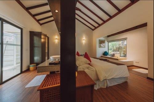 a bedroom with a bed and a desk and a window at BuBu Villa in Perhentian Islands