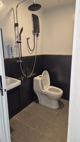 a bathroom with a shower and a toilet and a sink at Ilham Penarek Pantai Penarik in Pulau Che Selamah