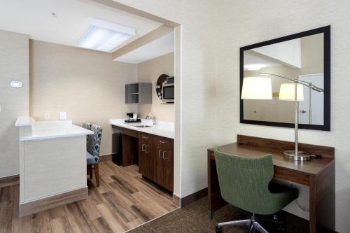a bathroom with a desk and a sink and a mirror at Hampton Inn Buffalo-South/I-90 in West Seneca