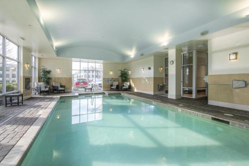 a large swimming pool in a hotel lobby at Hampton Inn & Suites Raleigh-Durham Airport-Brier Creek in Raleigh