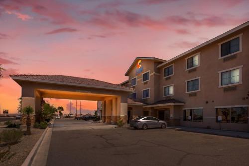 a hotel with a car parked in a parking lot at Comfort Inn and Suites Yuma I-8 in Yuma