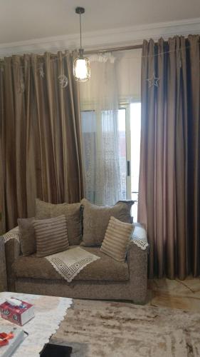 a living room with a couch in front of a window at فينوس in Hurghada