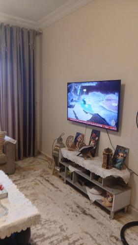 a living room with a flat screen tv on the wall at فينوس in Hurghada