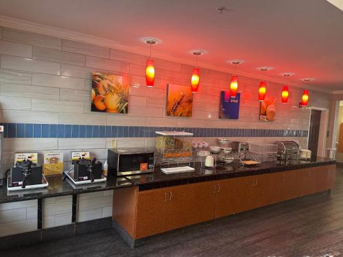 a restaurant kitchen with a counter with aperature at Comfort Inn & Suites North Charleston - Northwoods in Charleston Heights