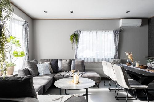 a living room with a couch and a table at THE CITYSCAPE in Kita-sanjō