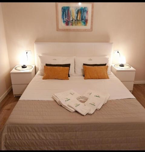 a bed with two pillows and two night stands at Il limone in Gargnano