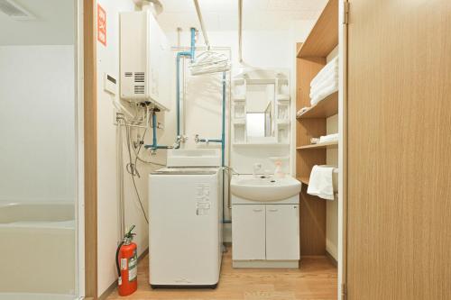 a small bathroom with a sink and a toilet at STAY IN PASSION in Asahikawa