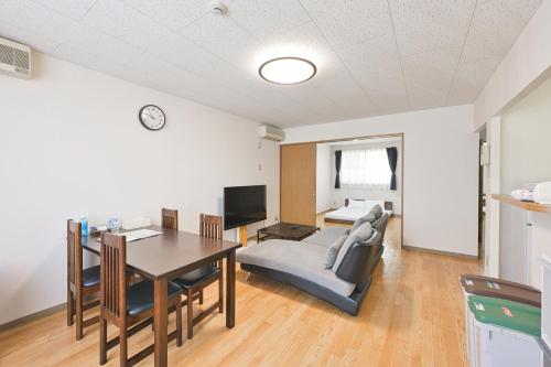 a living room with a table and a dining room at STAY IN PASSION in Asahikawa