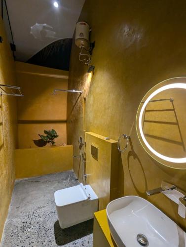 a bathroom with a sink and a mirror at Earth's Embrace in Kalpetta