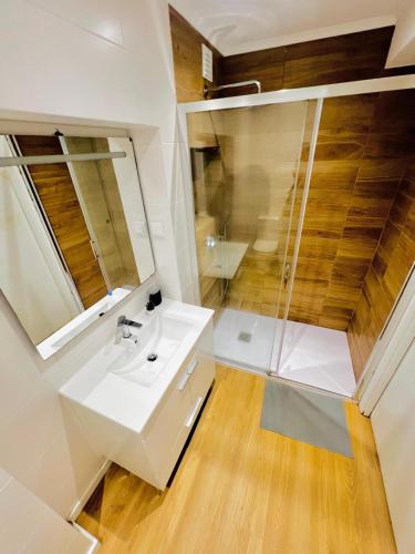 a bathroom with a white sink and a shower at High standard in Campo de Ourique, close to attractions in Lisbon
