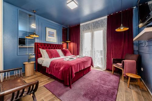 a bedroom with a red bed in a blue room at Villa Mart in Zadar