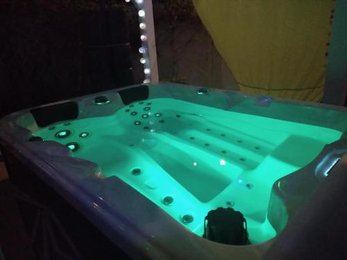 a jacuzzi tub in a dark room at Villa Madras in Sainte-Anne