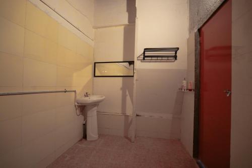 a small bathroom with a sink and a mirror at Home Stay in Arogyam at Mulshi Backwaters in Mulshi