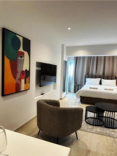 a hotel room with a bed and a tv at J Aurora in Nicosia