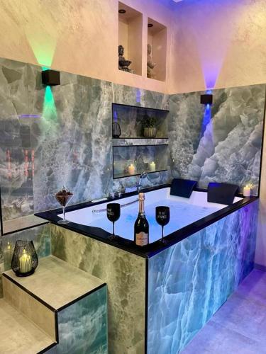 a bar with a bottle of wine on a counter at Aura Spa Oberhausen Premium in Oberhausen
