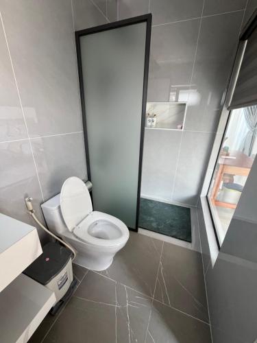 a small bathroom with a toilet and a window at Villa caribe phu quoc in Phú Quốc
